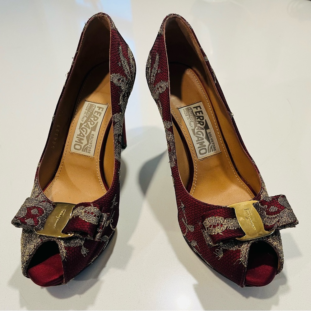 Show off your legs in these Salvatore Ferragamo Garnet and Gold Peep-Toe Heels.